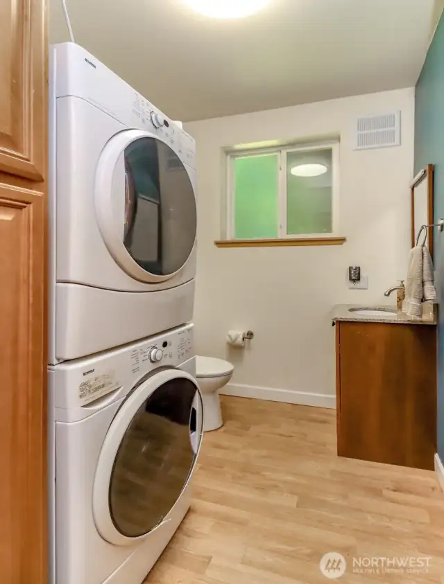 Convenient laundry room and half bath located at the bottom of the stairs