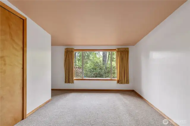 Bedroom 2 with access to the deck and a tucked around the corner work area.