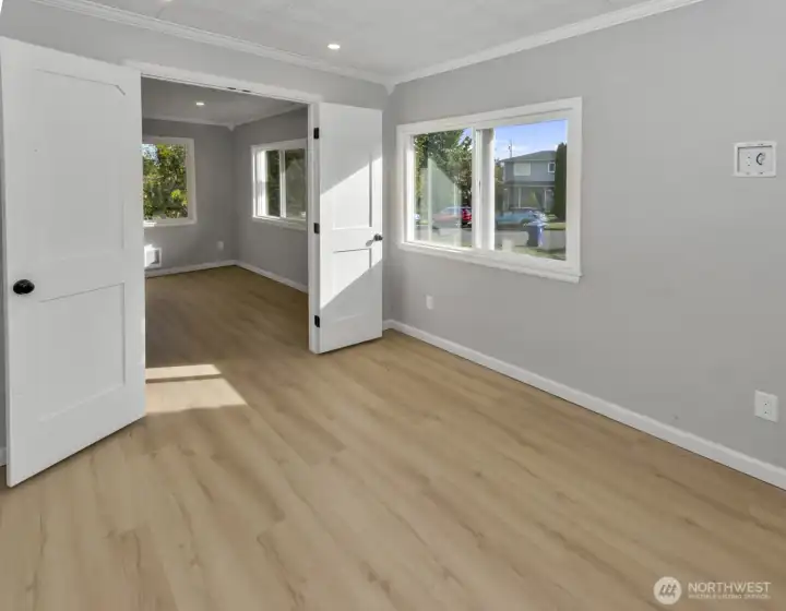 Office space peaking into living room through brand new french doors
