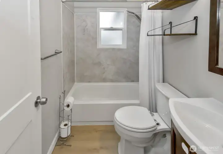 Bathroom with shower and tub and some shelving for storage