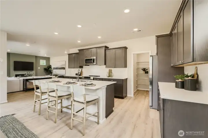 Kitchen and extra large pantry.  Photos are representation as the home is under construction.