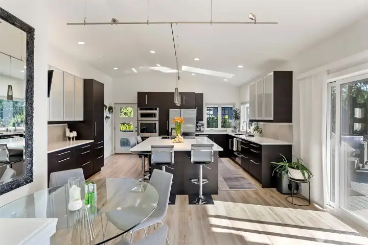 Open concept living with a smaller dining space off to the side and lovely corner bar seating at the island providing a great way to converse around dining and food preperation!