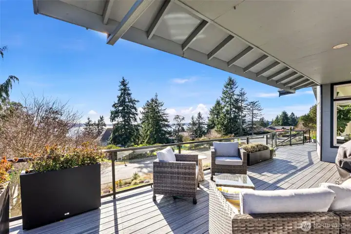 Views just of kitchen, dining and great room. You easily choose to be under cover when needed or out in the open. Newer decking and glass railing make for a clean loo and views less obstructed.