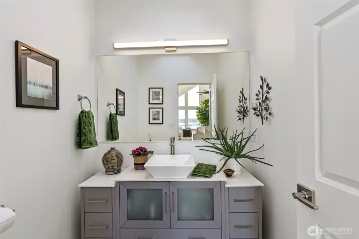 The Powder room with skylight is light and bright and clean. It's off the main living just enough to allow privacy for your guests.