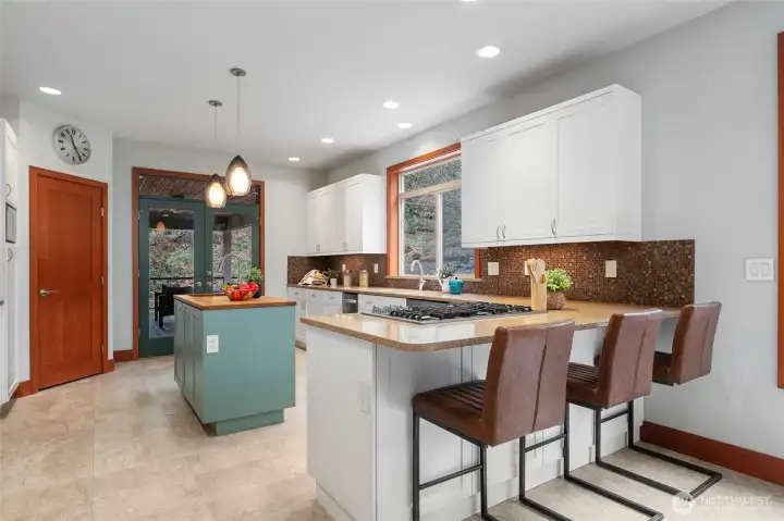 Gorgeous kitchen. Breakfast bar, gas range, tile backsplash and large pantry.
