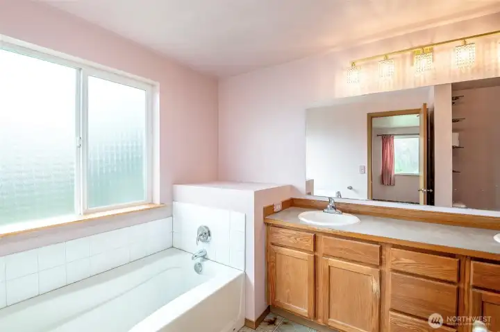 Huge primary bath with soaking tub, double sink vanity, shower and toilet