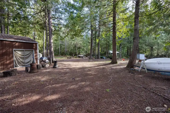 Cleared area and metal framed shop with sliding barn door.
