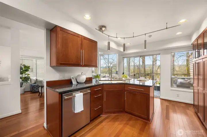 The L-shape island anchors the Kitchen footprint with extra counter space and storage cabinetry