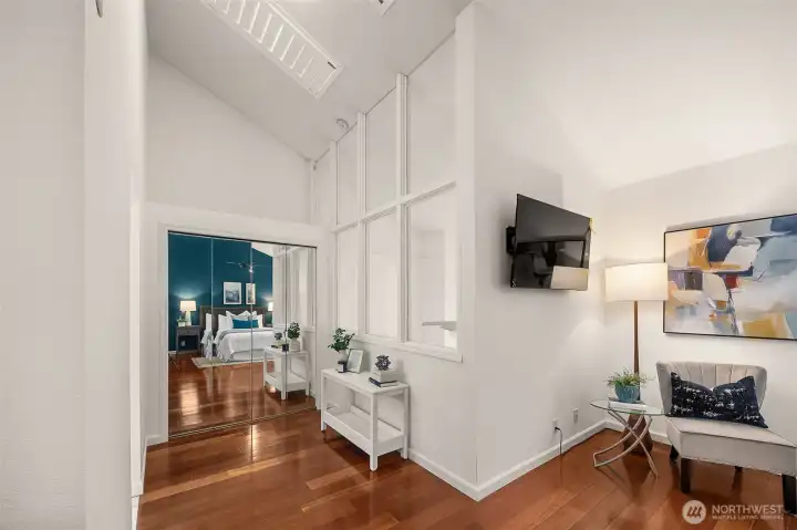 As an upgrade, this home has enclosed the lofted primary suite for privacy. The window wall was a thoughtful design to maximize natural light