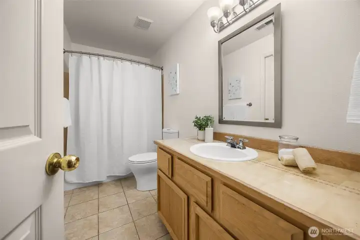 Full bath in the daylight basement with both bedroom and rec/family room access