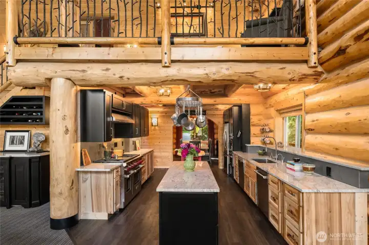 That dream cabin kitchen: natural wood, granite counters, and all the cozy vibes.