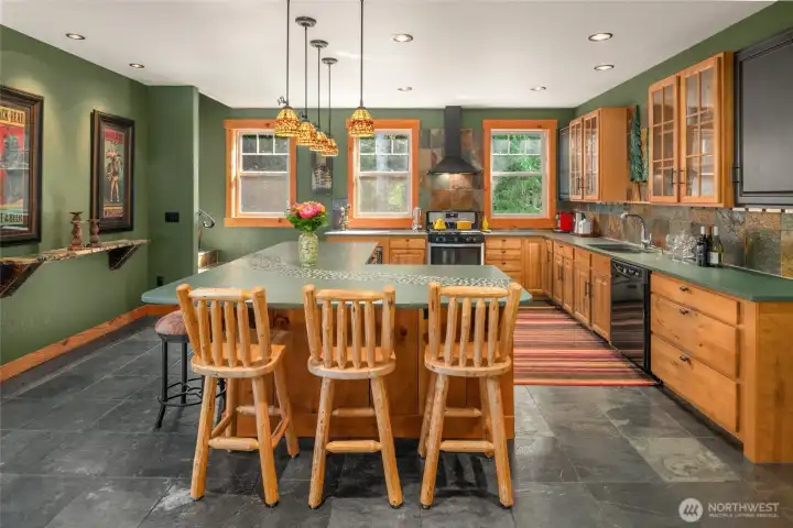 The 2nd kitchen with breakfast bar, honed slate countertop and custom lighting