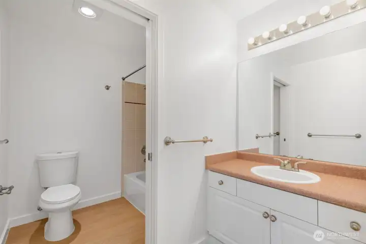 The full bath on this floor with a tiled surround and the new flooring goes into the bath as well.