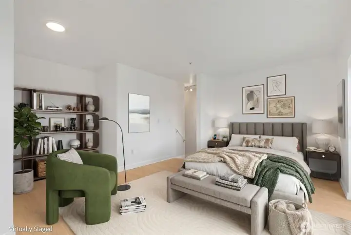 The stairwell leads up to the lofted primary - room for a queen bed with nooks for office, and a large walk in closet.