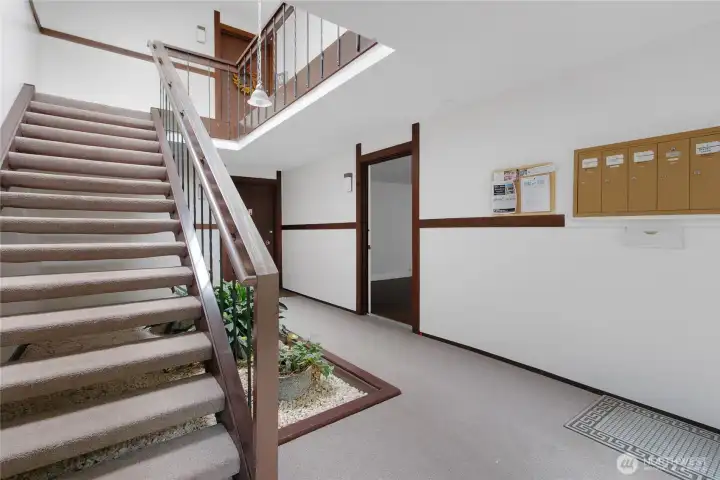 Front door to your new home to the right of the stairs.