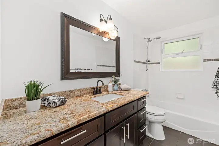 Large guest bathroom with oversized counter.  Many upgrades throughout the house.