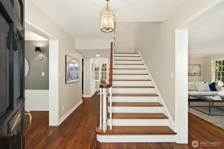 The gracious entry is anchored by a sweeping hardwood staircase, an elegant focal point rich in classic architectural detail.