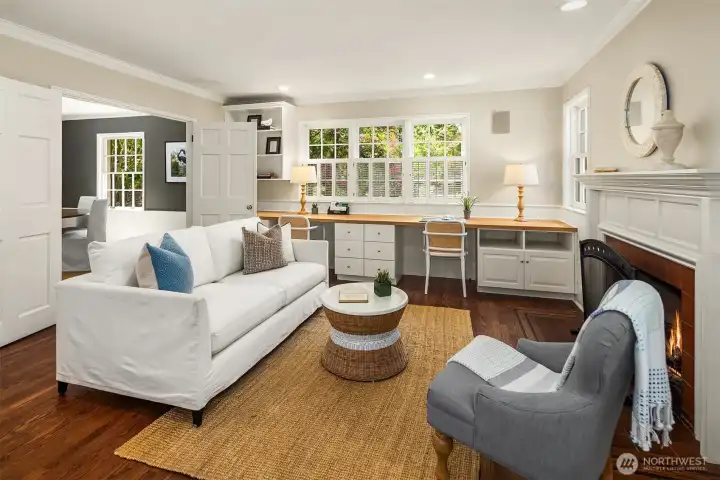 Open to the kitchen, this comfortable family room serves as the heart of the home, complete with a gas fireplace and a generous built-in desk area with abundant shelving for work, homework, or creative pursuits.
