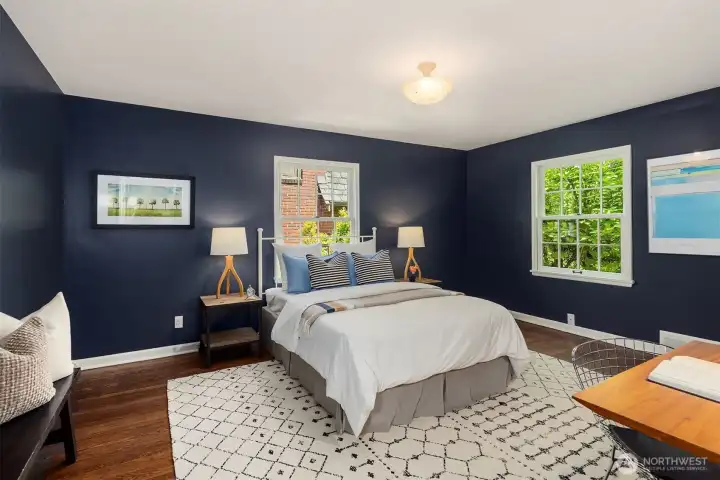 Generously proportioned and filled with possibility, this oversized bedroom offers ample room for both rest and productivity, easily accommodating a dedicated workstation, sitting area, or study space.