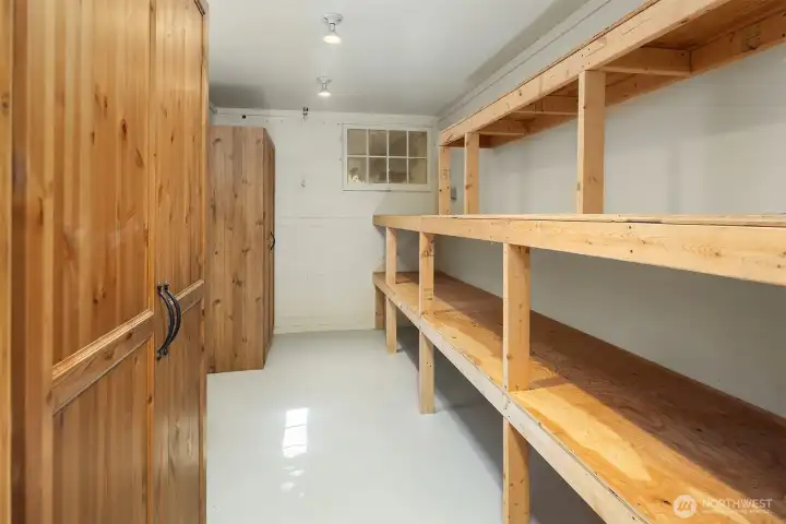 Storage is anything but an afterthought here. This expansive lower-level storage area features extensive built-in shelving and cupboards, offering exceptional space for seasonal items, hobbies, collections, and household organization.