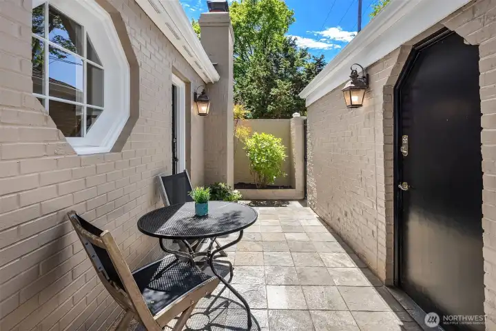 Tucked alongside the home, this charming patio offers a peaceful spot to relax, garden, or enjoy a morning coffee, with convenient access to the two-car garage.