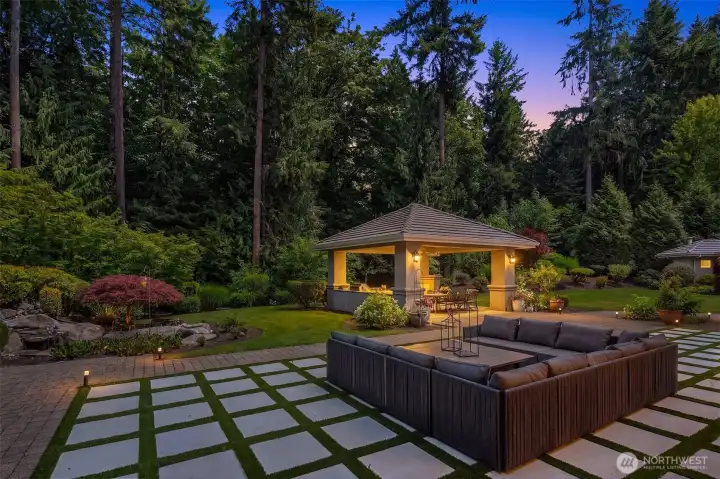 Artfully redesigned for modern luxury and effortless entertaining, the backyard showcases a newly installed architectural terrace featuring large-format concrete pavers interwoven with a low-maintenance turf grid
