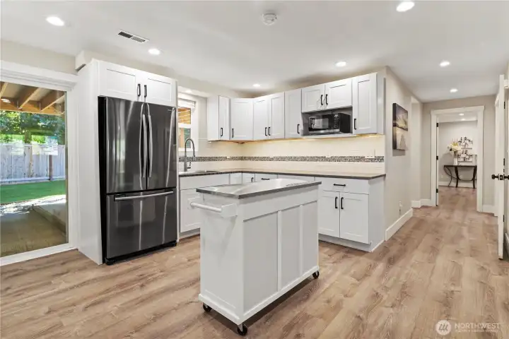 And now even more - kitchenette with full sized frig, microwave, sink & lots of counterspace. Multi-generational living? Easy to add a stove if you needed. Now, great space for party platters! And now even more - kitchenette with full sized frig, microwave, sink & lots of counterspace. Multi-generational living? Easy to add a stove if you needed. Now, great space for party platters!
