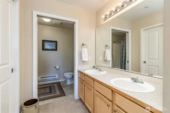Double sinks and a separate toilet/shower room in the primary suite