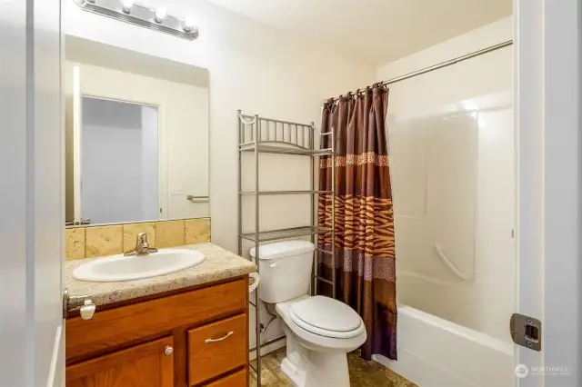 The main bathroom with shower and tub is in the hallway with the second and third bedrooms.