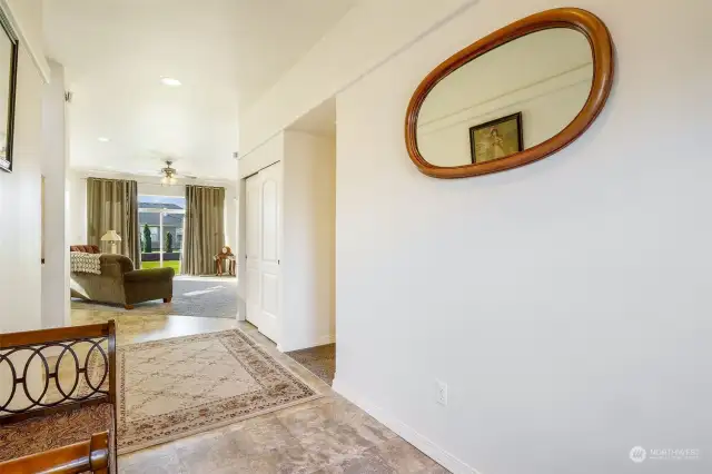 The front entryway is wide enough for a sitting bench and leads into the living room.