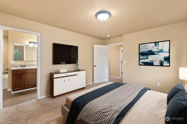 This is the Primary suite with a 5-piece bath and large walk in closet. Photo is virtually staged.