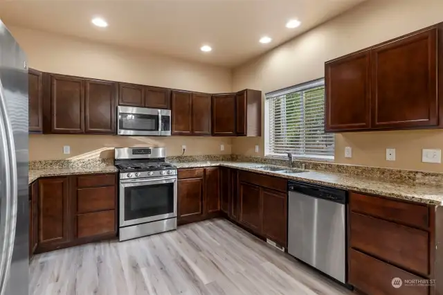 Big cooks kitchen with SS appliances that all convey with the home, lots of granite counterspace plus pending of cabinets and drawers.