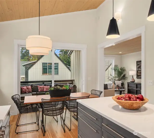 The stunning kitchen overlooks and opens to a lovely, covered upper terrace, ready for year round dining.