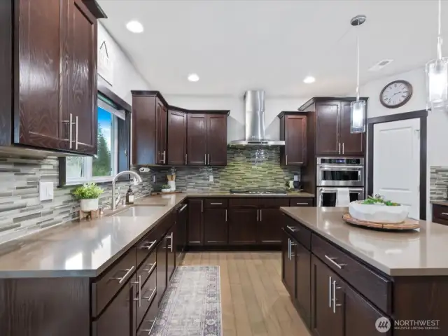 A chef’s dream! This stunning kitchen boasts high-end appliances, ample counter space, stylish cabinetry, and a spacious island—ideal for meal prep and casual dining.