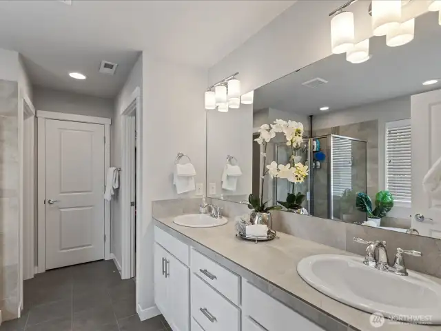 En-Suite off primary bedroom features dual vanities, soaking tub, large shower and walk-in closet.