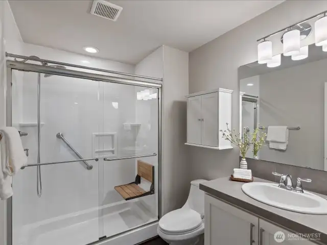Three-quarter bath in basement with accessible shower.