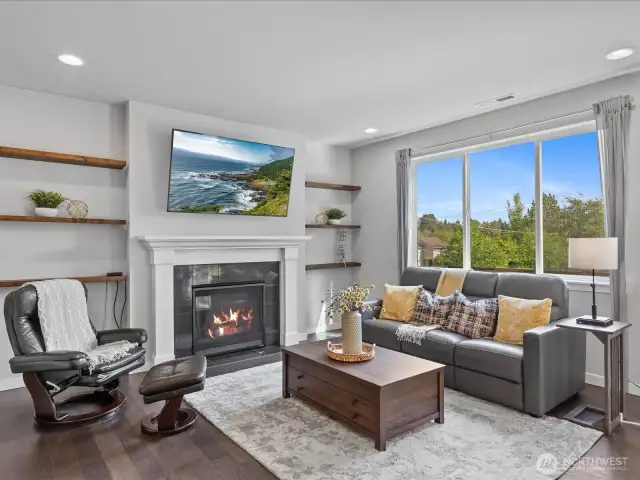Living room features cozy gas fireplace and luxury vinyl plank flooring.