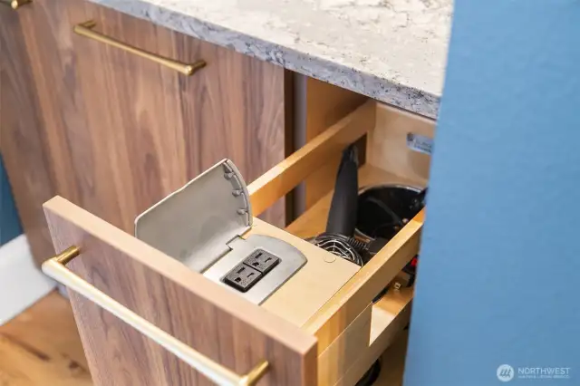 Pull-out cabinet in bathroom with built-in hair dryer plug-in