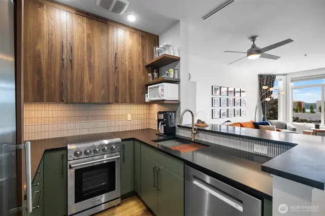 Newly updated kitchen features granite counters, INAX tile backsplash, custom cabinetry, Thor oven, open shelving, and a breakfast bar.