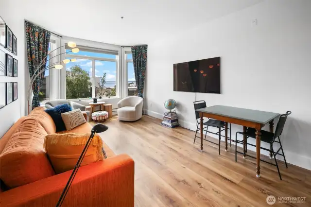 Living Room with couch that pulls out into Queen bed and thoughtfully stores all bedding inside the couch.  All furnishing convey with full price offer!