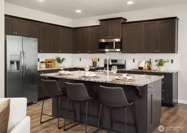 Gorgeous granite countertops and an abundance of cabinets