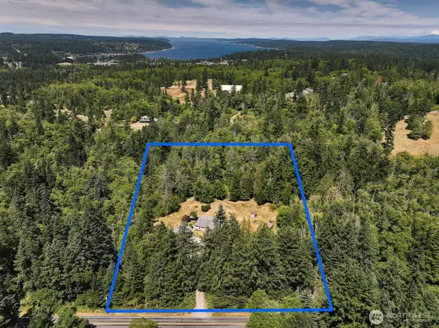 Look at all the forest surrounding you! So private and yet close to Robinson Beach, Double Bluff Beach and Freeland amenities. Enjoy your arrival as you meander down Lancaster Road to your gated driveway.