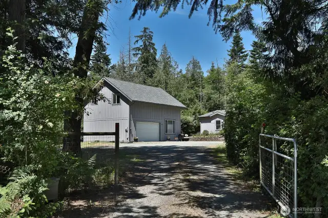 Gated entry for privacy. The oversized two car garage and shop has a +/- 864 sq ft guest apartment with a kitchen, bedroom & full bath.