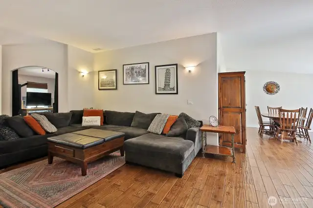 Your back is to the hallway that leads to the 2nd Bedroom, two Flex Rooms and Full Bath. The open arch way behind the sofa is an office space that is adjacent to the Primary Suite.