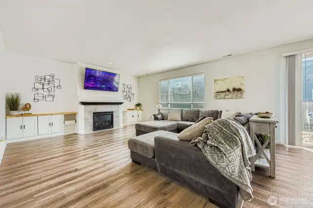 Enormous family room with a cozy gas fireplace and built-ins for a focal point. The open concept design creates a bright and inviting space, perfect for entertaining and relaxing.