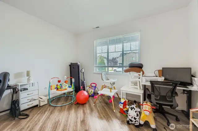 This main floor office area presents a fantastic opportunity, as it is generously sized and easily adaptable. It currently functions as both an office and a versatile multipurpose space, but its dimensions comfortably accommodate the creation of a sizable main floor bedroom, offering added convenience and flexibility to the property.