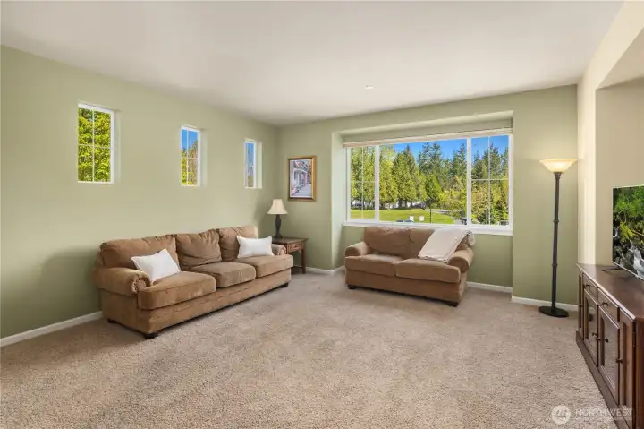 A large window in the living room frames the scenic view.