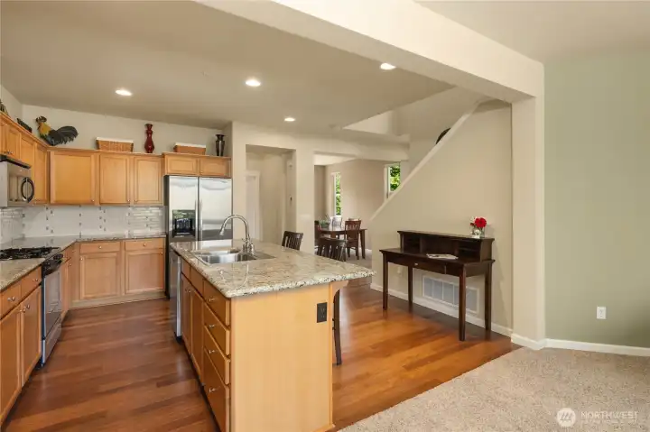 Sparkling countertops and full-height backsplash add to the appeal of this kitchen.