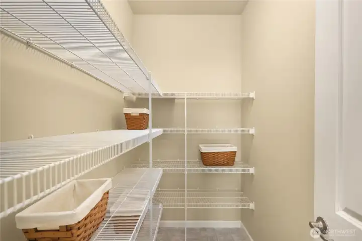 A walk-in pantry provides space for all your storage needs.