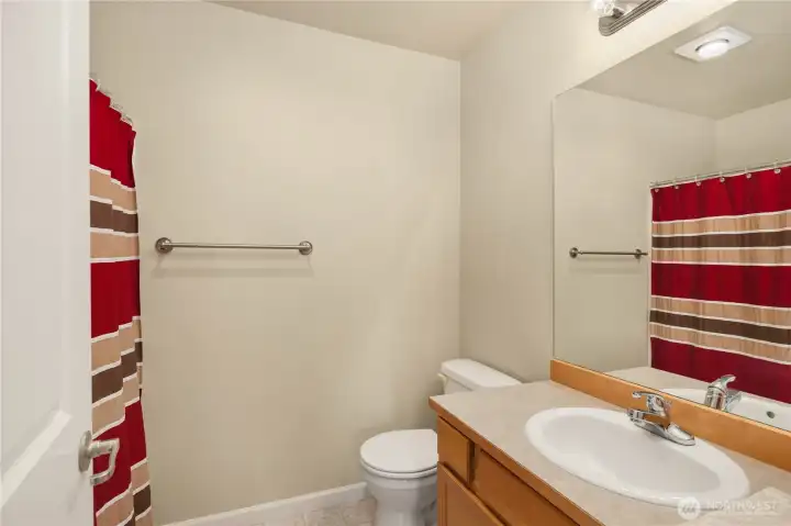 Full bath with tub/shower combo.